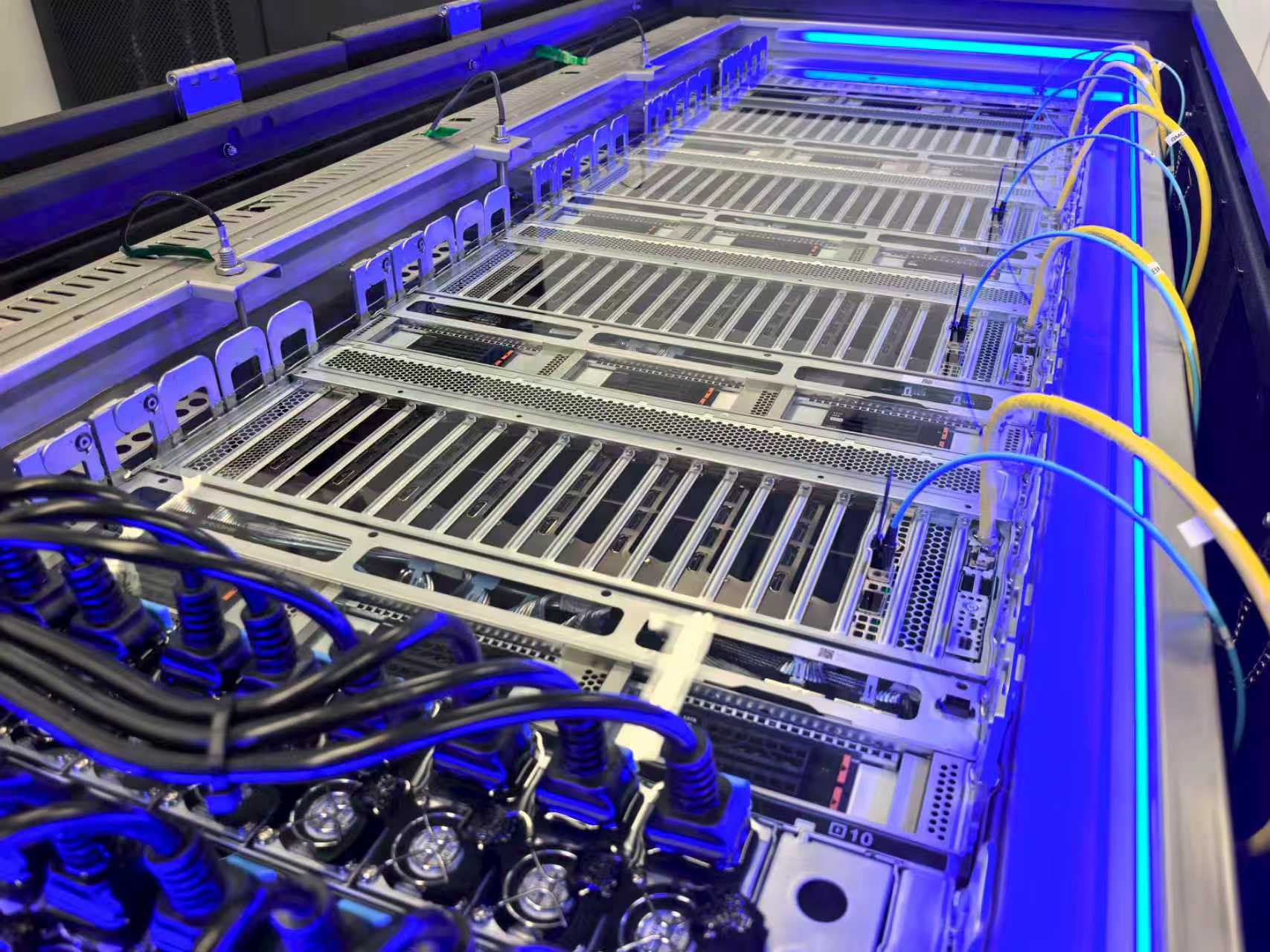 Interior of a single-phase immersion cooling tank with GPU servers submerged in dielectric fluid